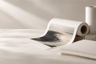 Fine-art inkjet paper rolls and archival print in a warm studio